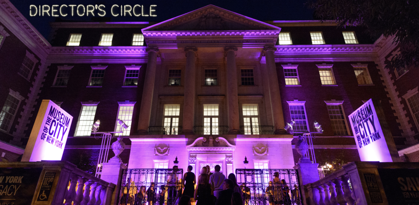 Entrance to a museum lit with purple light for a party. 
